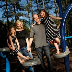 Hillary and Bryan Cole pose for a photograph with their daughters Hazel, 5, and Hannah, 8,  at Jetton Park Tuesday, April 12, 2017, in Cornelius, North Carolina.