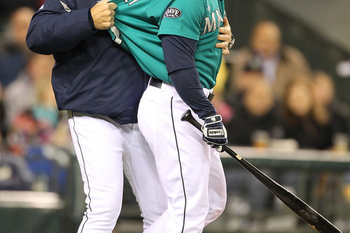 Milton Bradley of the Seattle Mariners is restrained by manager Eric Wedge after being ejected from the game against the Chicago White Sox at Safeco Field on May 6, 2011 in Seattle, Washington. (Photo by Otto Greule Jr/Getty Images)