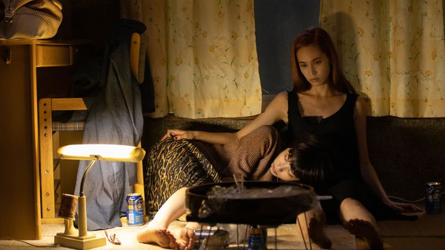 Kiko Mizuhara and Honami Satô sit together in a moody, underlit room in Ride or Die