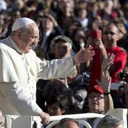 Pope Francis waves to faithful as he arrives for his weekly general audience, in St. Peter's Square at the Vatican, Wednesday, Nov. 19, 2014. (AP Photo/Andrew Medichini)