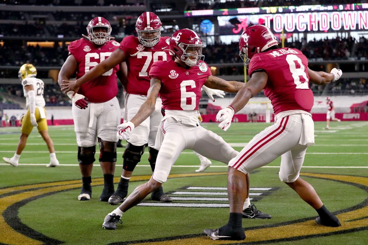 Wide receiver DeVonta Smith of the Alabama Crimson Tide celebrates his touchdown with teammate wide receiver John Metchie III in the first quarter of the 2021 College Football Playoff Semifinal Game at the Rose Bowl Game presented by Capital One against Notre Dame Fighting Irish at AT&amp;T Stadium on January 01, 2021 in Arlington, Texas.