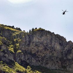 A helicopter recovers the body of Tyler Mayle, 22. The BYU student went hiking up the block "Y" mountain east of Provo Utah last Saturday and he didn't return when expected. Rescuers found his body Wednesday but wasn't able to recover his body till Thursday morning. Thursday, June 6, 2013
