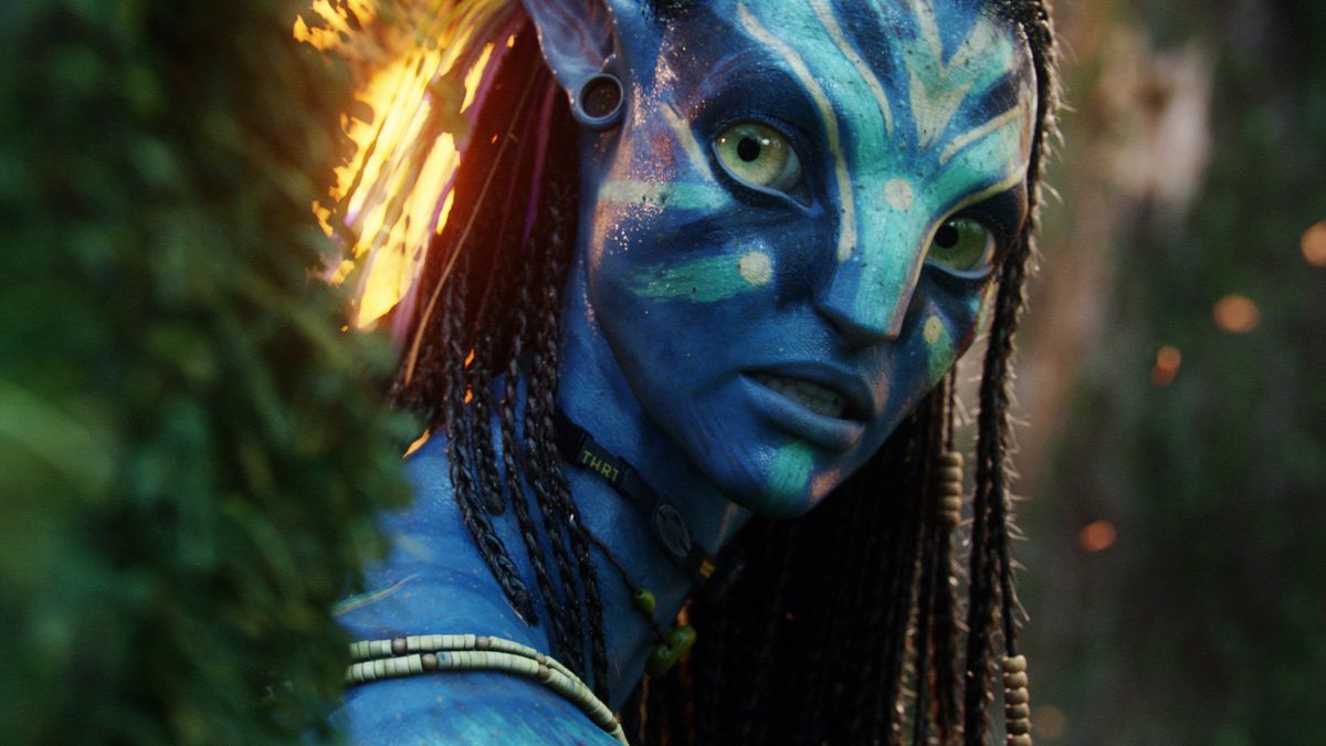 Neytiri, a blue-skinned alien with big eyes and tight braids in her hair (Zoe Saldana), in Avatar.
