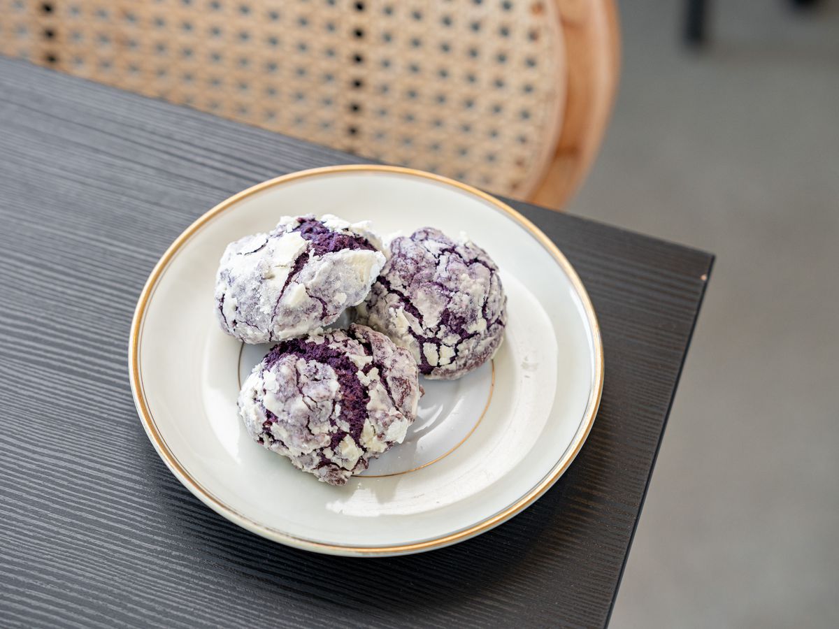 A plate of ube crinkle cookies sits on a plate at Botanical Bakeshop’s Shop Halo Halo.