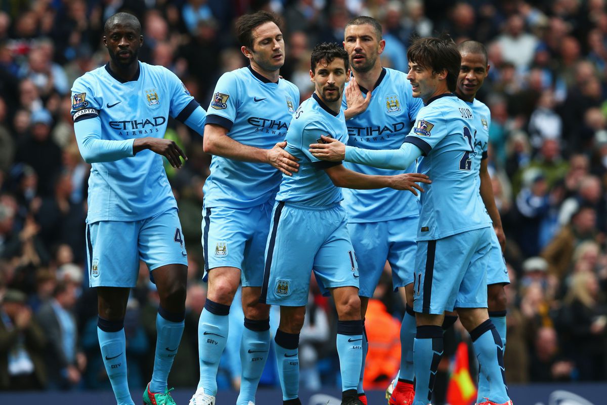 Manchester City players celebrate after James Collins of West Ham (not pictured) scored an own goal during the Barclays Premier League match between Manchester City and West Ham United at Etihad Stadium on April 19, 2015 in Manchester, England.