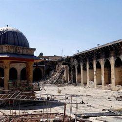 This journalism image provided by Aleppo Media Center AMC which has been authenticated based on its contents and other AP reporting, shows the damaged famed 12th century Umayyad mosque without the minaret, background right corner, which was destroyed by the shelling, in the northern city of Aleppo, Syria, Wednesday April 24, 2013. The minaret of a famed 12th century Sunni mosque in the northern Syrian city of Aleppo was destroyed Wednesday, leaving the once-soaring stone tower a pile of rubble and twisted metal scattered in the tiled courtyard. President Bashar Assad's regime and anti-government activists traded blame for the attack against the Umayyad mosque, which occurred in the heart Aleppo's walled Old City, a UNESCO World Heritage site. It was the second time in just over a week that a historic Sunni mosque in Syria has been seriously damaged. (AP Photo/Aleppo Media Center, AMC)