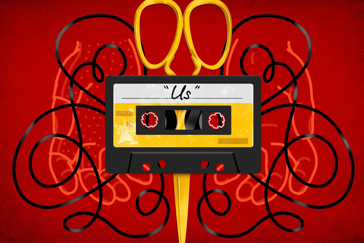 A tape cassette titled ‘Us’ with giant scissors in the background