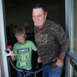 Duane Feragen and his son, Isaac, 11, walk out the door with a free bicycle at Lantern House in Ogden on Friday, July 22, 2016. Lantern House gives out the donated bicycles to some of its guests who can benefit from the added mobility.