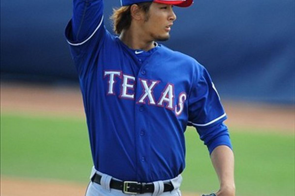 Mar. 7, 2012; Peoria, AZ, USA; Texas Rangers pitcher Yu Darvish pitches in the first inning against the San Diego Padres at Peoria Stadium.  Mandatory Credit: Mark J. Rebilas-US PRESSWIRE