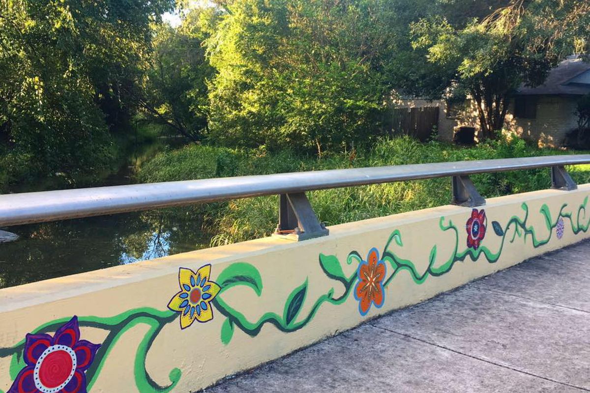 Short concrete bridge with mural of flowers