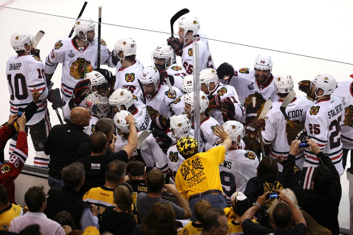Brent Seabrook celebrates with teammates after winning game four in overtime