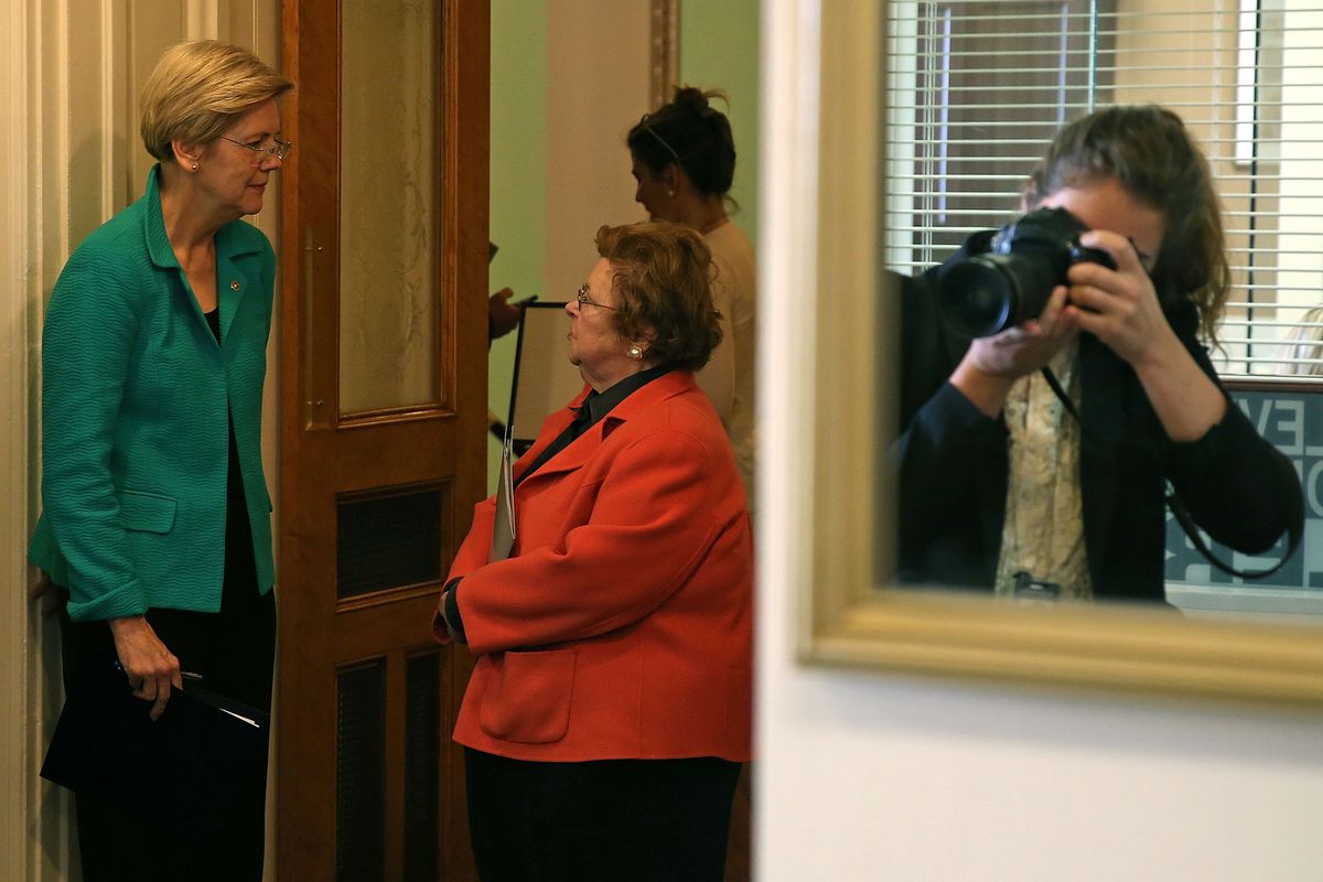 Elizabeth Warren, left, talks with Barbara Mikulski. Mikulski negotiated the CRomnibus, which Warren now opposes. 