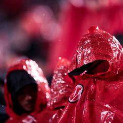 Utah Utes fans huddle under ponchos as rain falls during the game against the Washington State Cougars at Rice-Eccles Stadium in Salt Lake City on Saturday, Sept. 28, 2019.