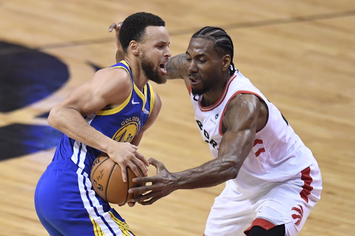 Toronto Raptors forward Kawhi Leonard (2) defends against Golden State Warriors guard Stephen Curry (30) during first-half basketball action in Game 5 of the NBA Finals in Toronto, Monday, June 10, 2019.