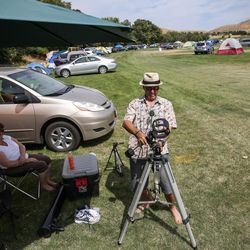 Eric Wheeler, of Roseville, Calif., sets up his telescope as he and his wife, Lisa, left, prepare for Monday's total solar eclipse at Weiser High School in Weiser, Idaho, on Sunday, Aug. 20, 2017.