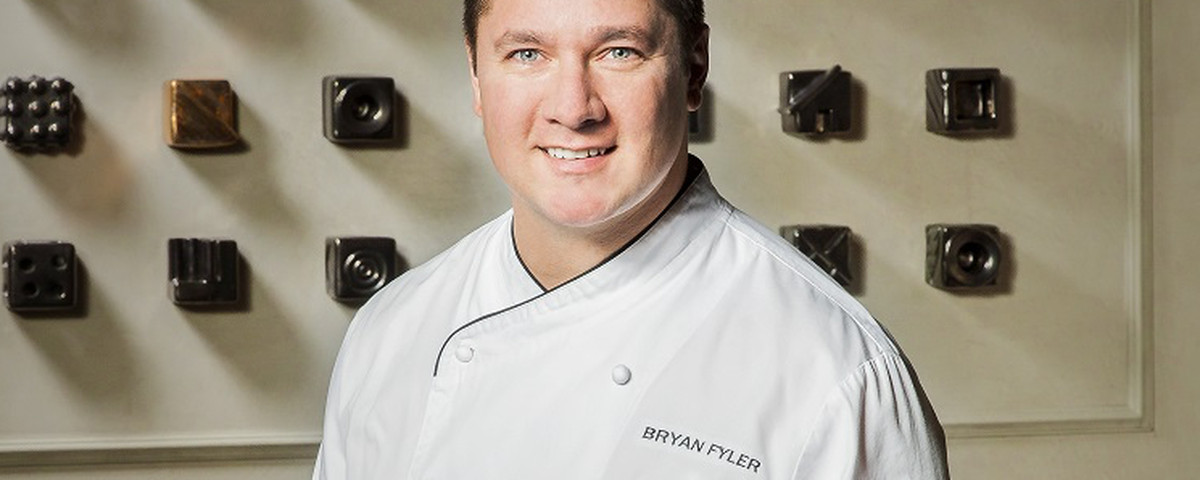Bryan Fyler wearing a white chef coat