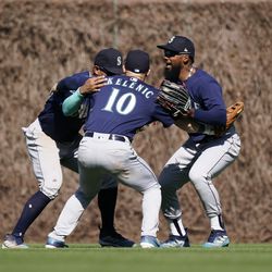 (L-R) Julio Rodriguez #44, Jarred Kelenic #10, and Teoscar Hernandez #35 of the Seattle Mariners celebrate at the end of their win over the Chicago Cubs at Wrigley Field on April 12, 2023 in Chicago, Illinois. The Mariners defeated the Cubs 5-2.