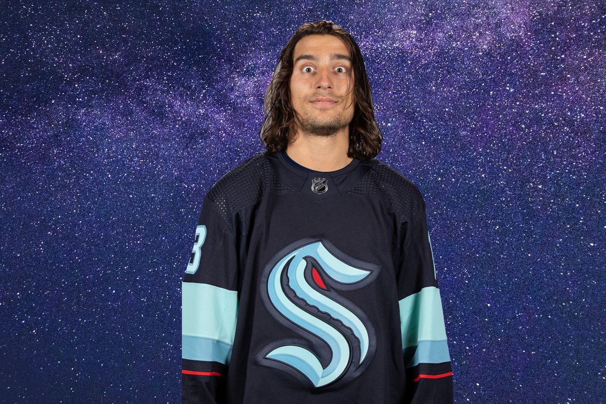 Brandon Tanev’s headshot with a background of a starry night sky