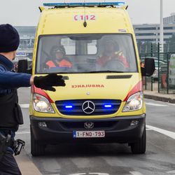 Ambulances arrive to the scene at Brussels airport, after explosions rocked the facility in Brussels, Belgium, Tuesday March 22, 2016. Authorities locked down the Belgian capital on Tuesday after explosions rocked the Brussels airport and subway system, killing at least 34 people and injuring many more. Belgium raised its terror alert to its highest level, diverting arriving planes and trains and ordering people to stay where they were. Airports across Europe tightened security.