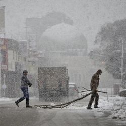 Palestinians cross a snow-blanketed street in the West Bank City of Nablus, Friday, Feb. 20, 2015.  A heavy winter storm hit parts of the Middle East on Friday, shutting down roads leading in and out of Jerusalem and sprinkling areas of Israel's desert with a rare layer of white. Snow also fell in parts of the West Bank, Lebanon, Jordan and Syria as a cold front swept through the region. 