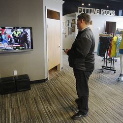 Daniel Mauer watches news reports at Salt Lake Running Company in Salt Lake City Monday, April 15, 2013, after explosions near the finish line of the Boston Marathon. 