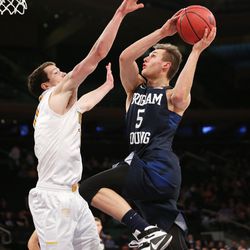 Brigham Young Cougars guard Kyle Collinsworth (5) pushes up a shot over Valparaiso Crusaders forward David Skara (10) as BYU and Valparaiso play in NIT Semifinal action at Madison Square Garden in New York City Tuesday, March 29, 2016.