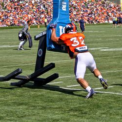 Broncos FB Andy Janovich pushes the sled with force.