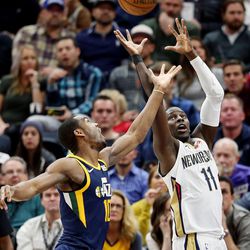 Utah Jazz guard Alec Burks (10) tries to defend a pass to New Orleans Pelicans guard Jrue Holiday (11) as the Utah Jazz and the New Orleans Pelicans play an NBA basketball game at Vivint Arena in Salt Lake City on Wednesday, Jan. 3, 2018.
