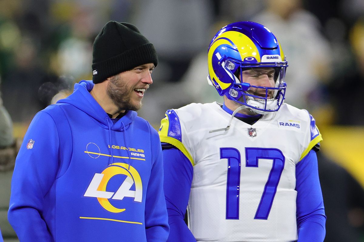 Matthew Stafford #9 and Baker Mayfield #17 of the Los Angeles Rams speak prior to a game against the Green Bay Packers at Lambeau Field on December 19, 2022 in Green Bay, Wisconsin. The Packers defeated the Rams 24-12.