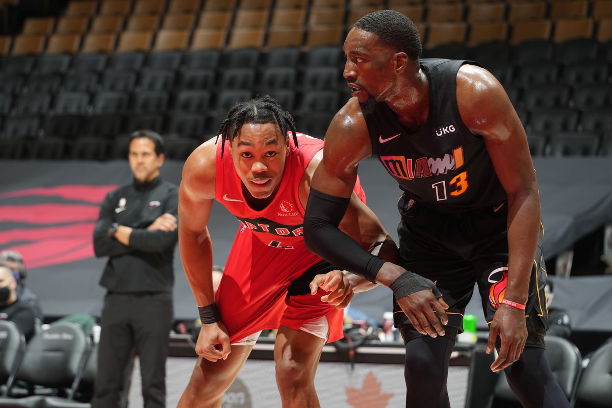 Scottie Barnes #4 of the Toronto Raptors and Bam Adebayo #13 of the Miami Heat fight for position during the game on February 1, 2022 at the Scotiabank Arena in Toronto, Ontario, Canada.