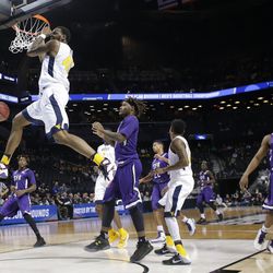 West Virginia's Elijah Macon (45) dunks the ball in front Stephen F. Austin's Clide Geffrard, Jr. (11) during the first half of a first-round men's college basketball game in the NCAA Tournament,Friday, March 18, 2016, in New York. (AP Photo/Frank Franklin II)