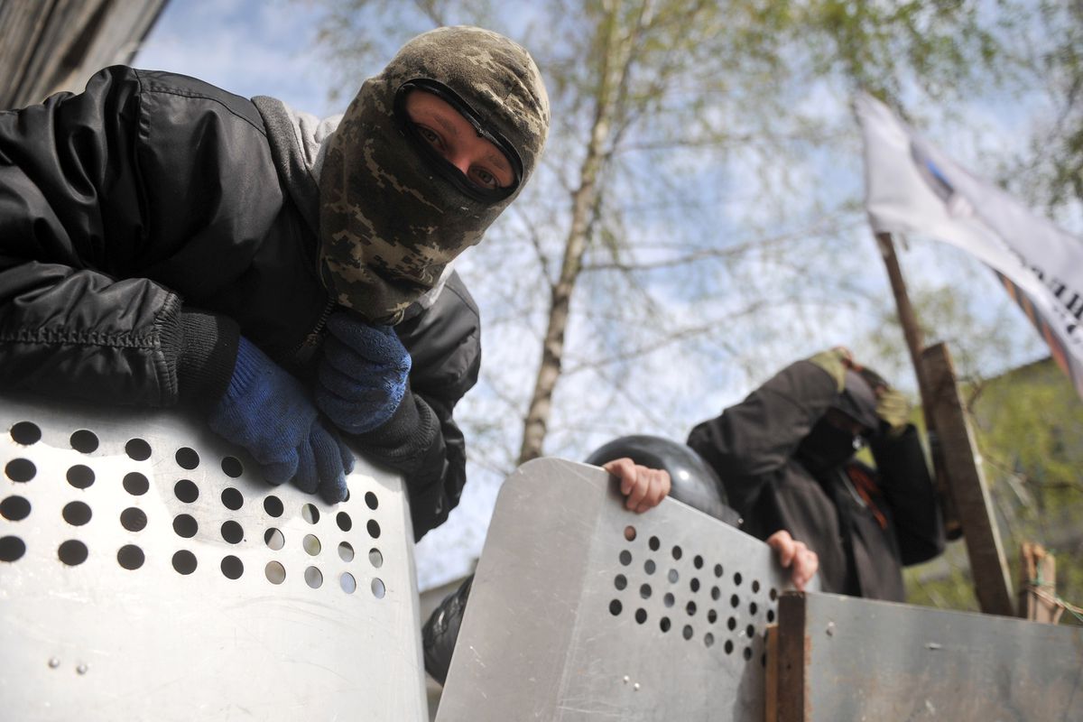 Pro-Russia militants guard a barricade outside the police regional building seized by the separatists in the eastern Ukrainian city of Slavyansk on April 17, 2014