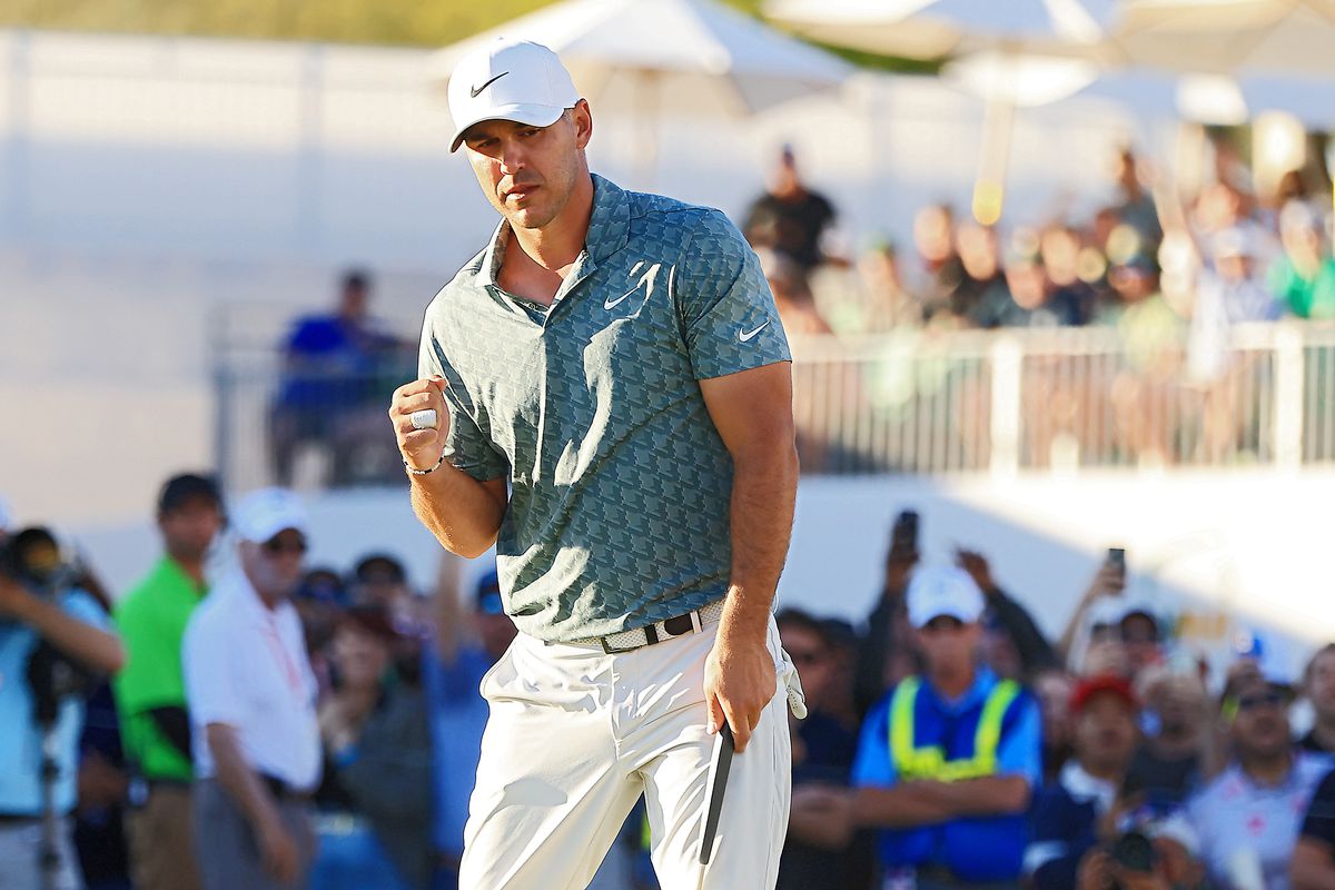 Brooks Koepka reacts after making a par putt on the 18th hole during the third round of the WM Phoenix Open at TPC Scottsdale on February 12, 2022 in Scottsdale, Arizona.