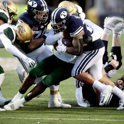 Brigham Young Cougars running back Tyler Allgeier (25) pushes ahead during a run as BYU and UAB play in the Radiance Technologies Independence Bowl in Shreveport, Louisiana, on Saturday, Dec. 18, 2021. UAB won 31-28.