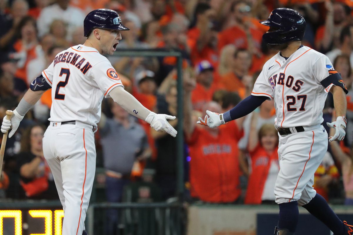 Jose Altuve of the Houston Astros celebrates with Alex Bregman after a lead-off home run during the first inning of Game One of the Division Series against the Minnesota Twins at Minute Maid Park on October 07, 2023 in Houston, Texas.