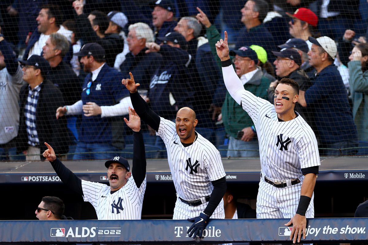Matt Carpenter, Aaron Hicks and Aaron Judge of the New York Yankees react to Giancarlo Stanton three-run home run against the Cleveland Guardians during the first inning in game five of the American League Division Series at Yankee Stadium on October 18, 2022 the Bronx borough of New York City.