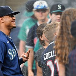 CLEVELAND, OH - SEPTEMBER 04: Julio Rodríguez #44 of the Seattle Mariners takes photos with fans during the rain delay during the game between the Seattle Mariners and the Cleveland Guardians at Progressive Field on Sunday, September 4, 2022 in Cleveland, Ohio.