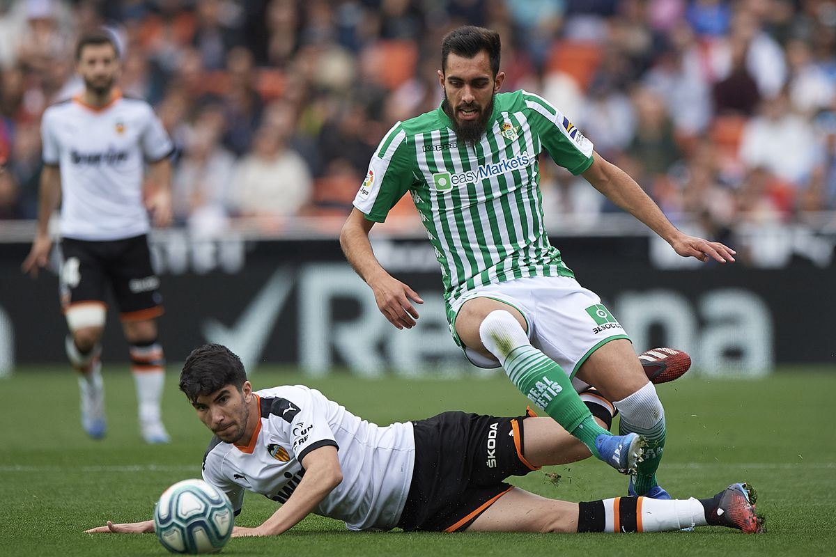 Carlos Soler of Valencia competes for the ball with Borja Iglesias of Betis during the Liga match between Valencia CF and Real Betis Balompie at Estadio Mestalla on February 29, 2020 in Valencia, Spain.