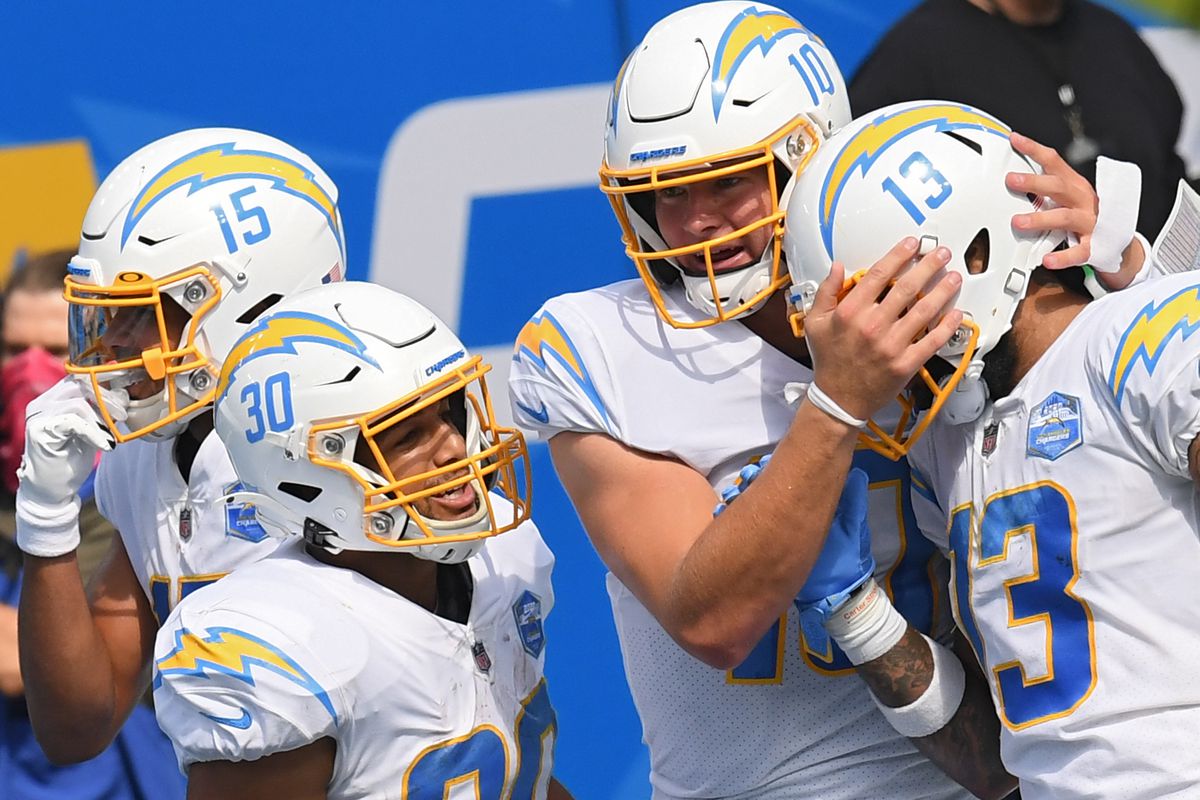 Quarterback Justin Herbert #10 of the Los Angeles Chargers celebrates his touchdown pass with wide receiver Keenan Allen #13 against the Kansas City Chiefs during the second quarter at SoFi Stadium on September 20, 2020 in Inglewood, California.