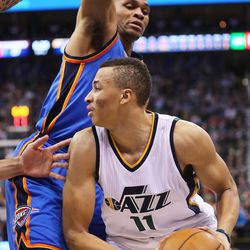 Utah Jazz guard Dante Exum (11) is defended by Oklahoma City Thunder guard Russell Westbrook (0) as the Jazz and the Thunder play at Vivint Smart Home arena in Salt Lake City on Wednesday, Dec. 14, 2016.