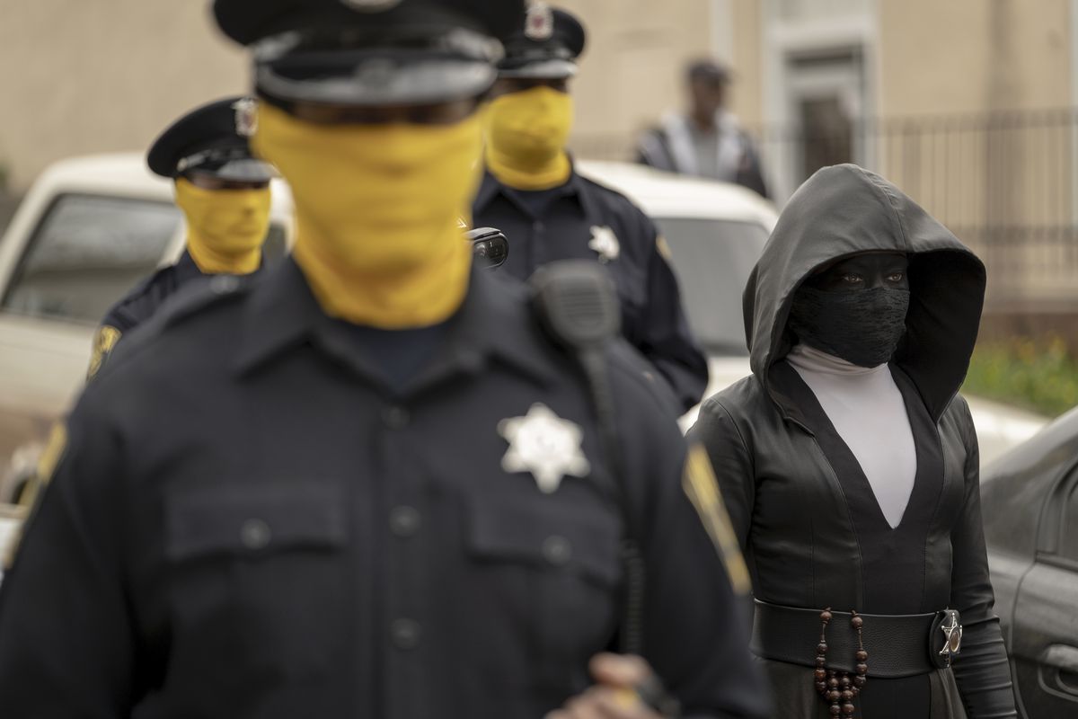 Regina King, shown here walking with masked police officers, stars in Watchmen.