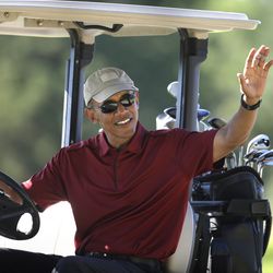 FILE - In this Aug. 14, 2015 file photo, President Barack Obama waves from a golf cart while golfing at Farm Neck Golf Club, in Oak Bluffs, Mass., during vacation on the island of Martha's Vineyard. The Obamas are taking their annual vacation on Martha's Vineyard as private citizens in August 2017, just weeks before eldest daughter Malia, is slated to start at Harvard. (AP Photo/Steven Senne, File)