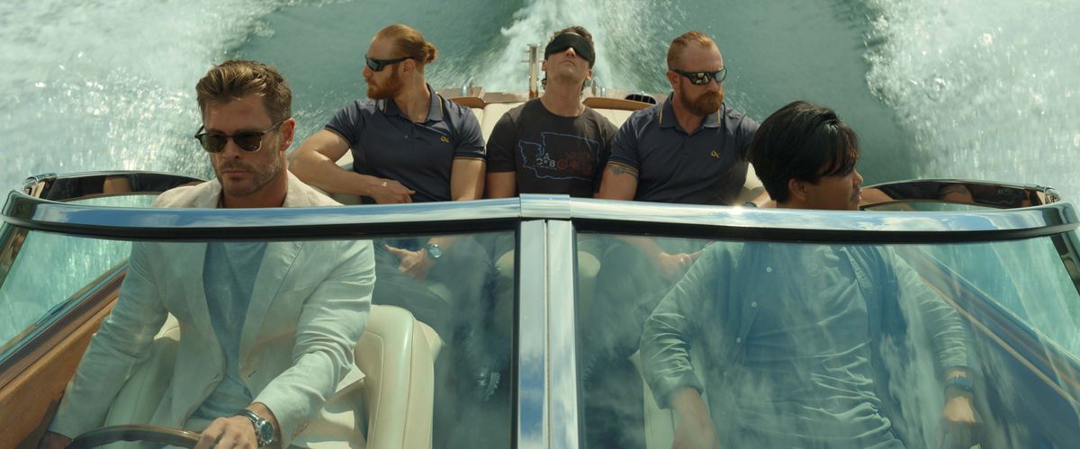 Chris Hemsworth and several others in a speedboat in Netflix's Spiderhead
