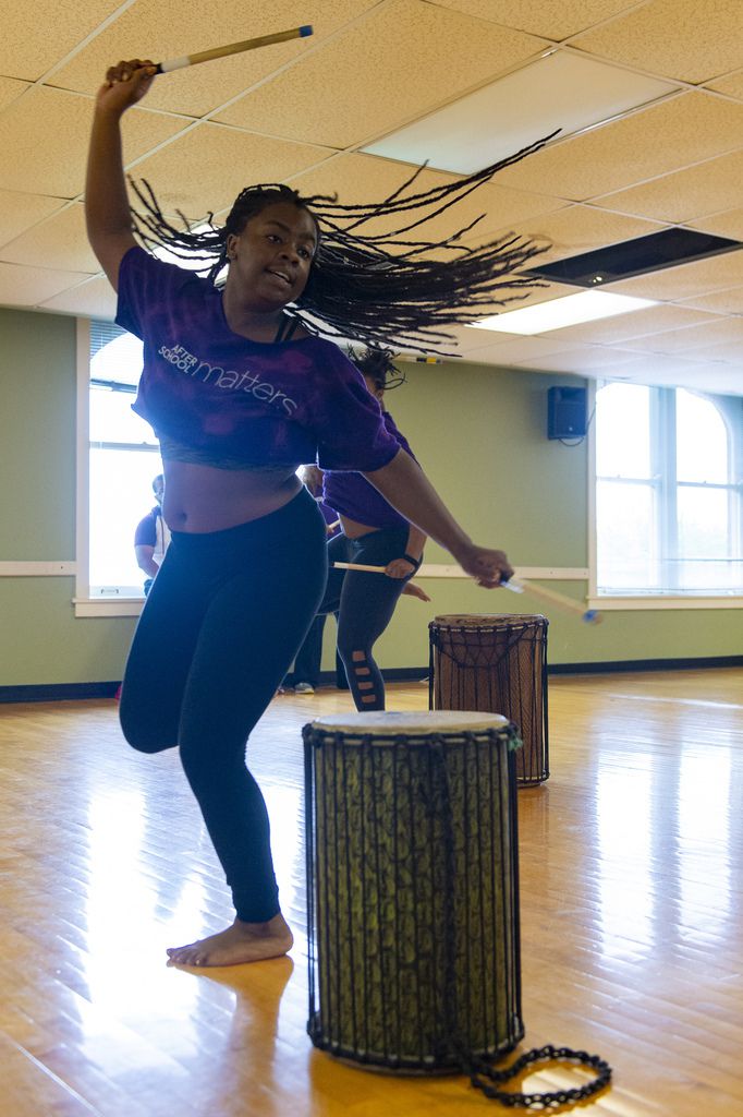 Aviwe DuBois of the Les Enfants Dance program dances while playing the drum during a practice of a traditional African “coming of age” song, Saturday, Sept. 8, 2018, in Chicago. | Tyler LaRiviere/Sun-Times