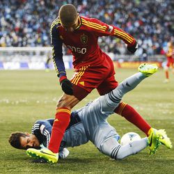 Real's Alvaro Saborio runs over Kansas City's Benny Feilhaber as Real Salt Lake and Sporting KC play Saturday, Dec. 7, 2013 in MLS Cup action.