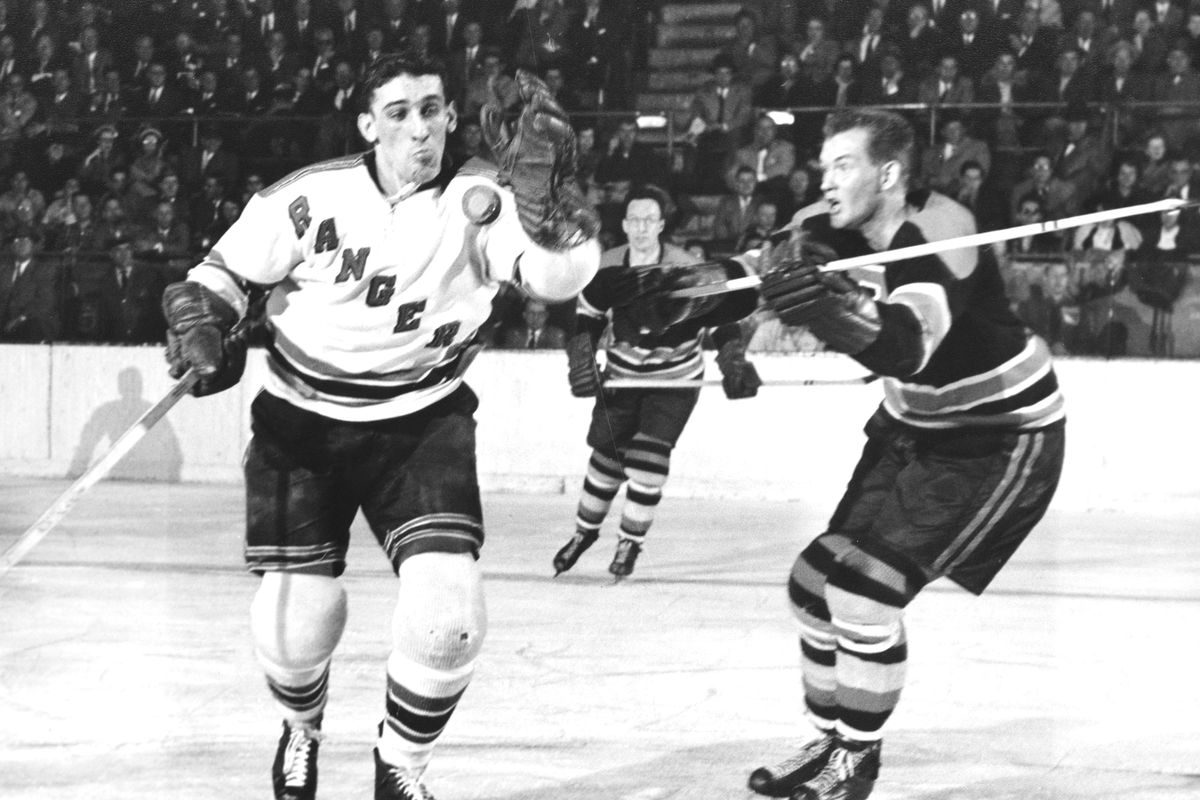 New York Rangers’ Lou Fontinato fights for loose puck with W