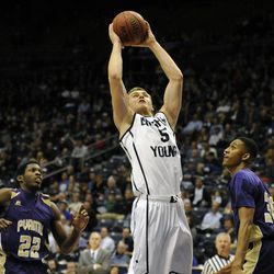 BYU guard Kyle Collinsworth (5) splits the defense of Prairie View A&M Panthers forward Rasi Jenkins (22) and Prairie View A&M Panthers forward Karim York (30) going to the basket during a game at the Marriott Center in Provo on Wednesday, Dec. 11, 2013.