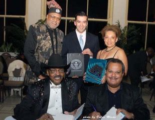 In 2009, David Smallwood co-authored the autobiography of the late Chicago DJ Herb Kent, “The Cool Gent:&nbsp;The Nine Lives of Radio Legend Herb Kent.” Here, Mr. Smallwood (front right) is seated next to Kent at the book launch. Behind him is the late civil rights activist Dr. Conrad Worrill (left) and Real Men Cook Founder Yvette Moyo.