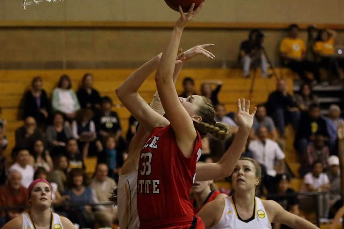 Dixie State senior center Taylor Mann (front-center) shoots over a defender at Dominican on Feb. 22. Mann was named PacWest Player of the Week for the fourth time on Monday. 