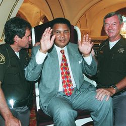 Muhammad Ali plays around with sheriff deputy's at the Capitol Theatre.